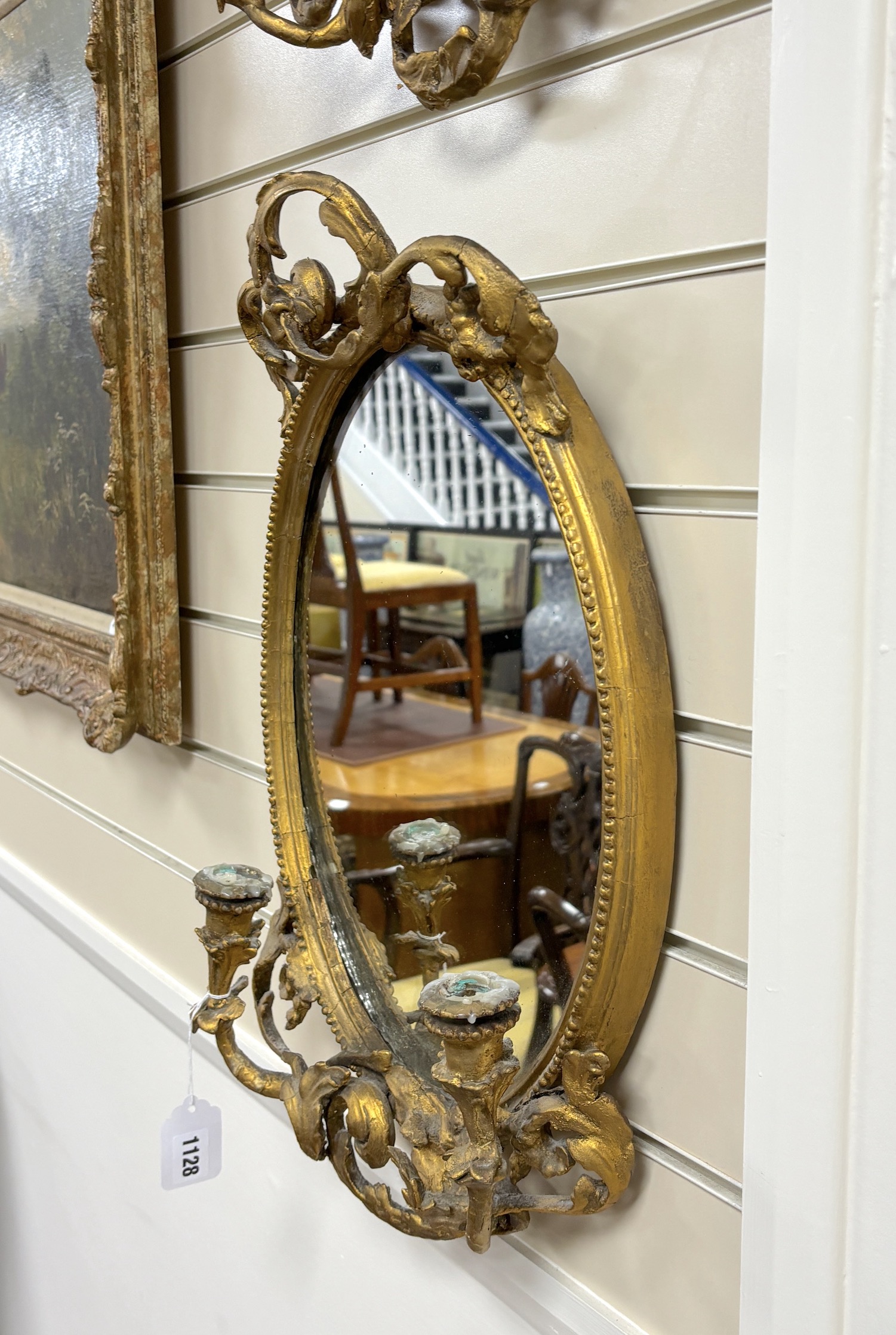 A pair of Victorian oval giltwood and composition girandole wall mirrors, width 34cm, height 55cm